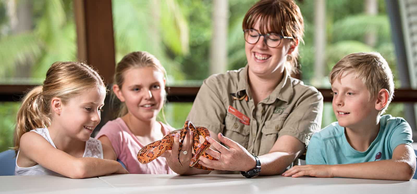 Kids smiling as Adelaide Zoo keeper holds snake