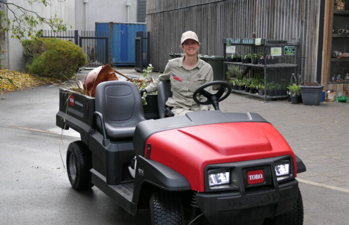 A horticultural team member on a Toro vehicle