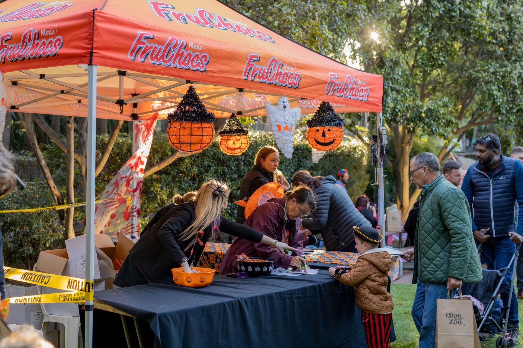Volunteers handing out treats to guests at Boo at the Zoo